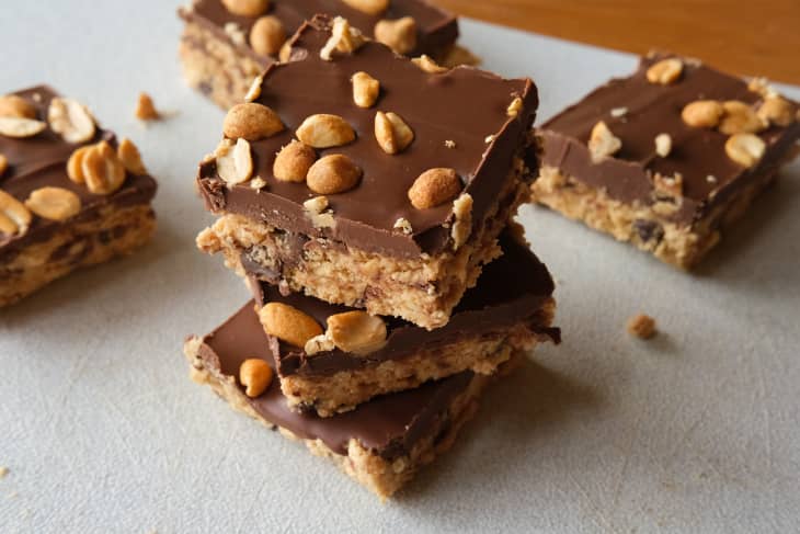 Peanut butter chocolate no-bake bars with peanuts on top stacked