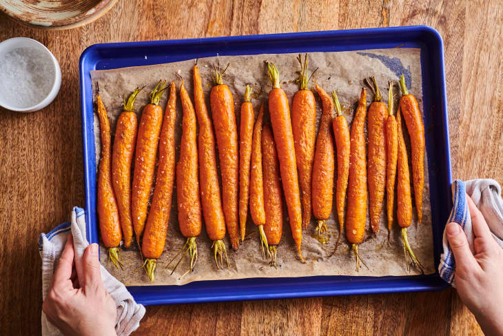 Roasted carrots on a blue baking sheet