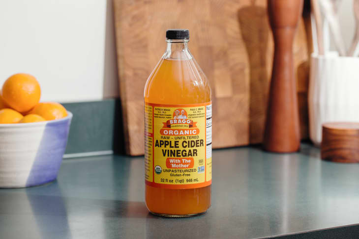 A bottle of apple cider vinegar on the kitchen counter