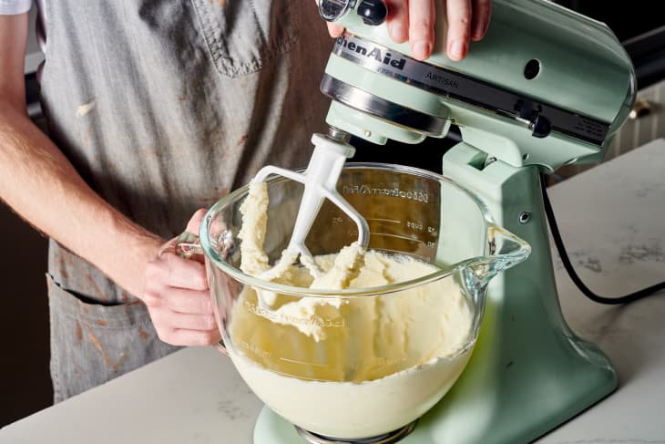 someone is mixing dough in a stand mixer