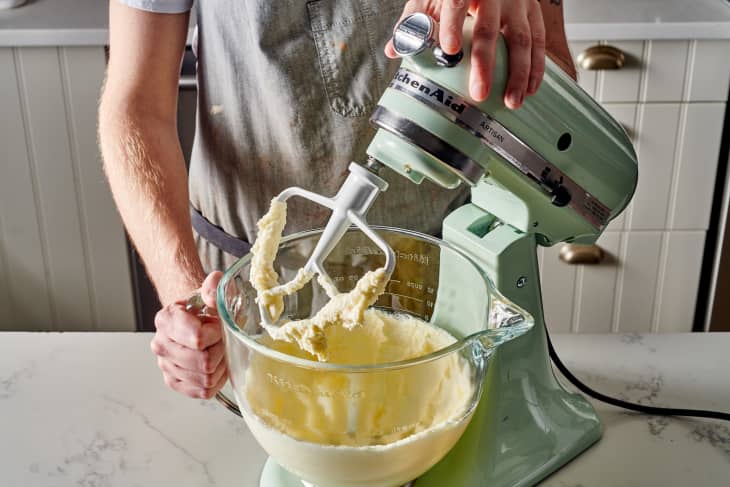 someone is mixing dough in a stand mixer
