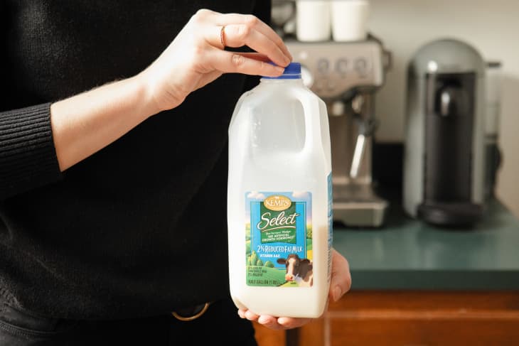 Someone holding jug of milk