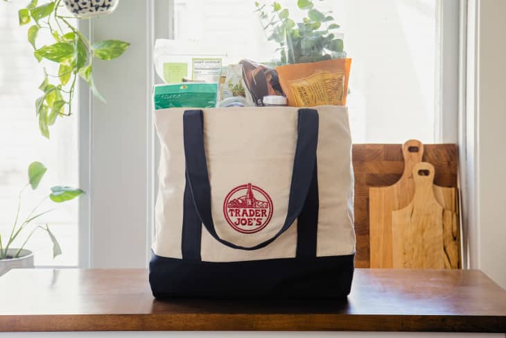 Trader Joe's canvas bag filled with groceries on countertop.
