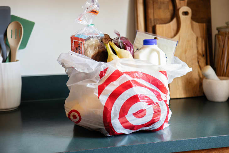 Plastic bag filled with groceries on kitchen counter.
