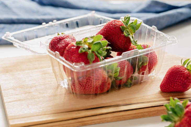 Strawberries in plastic clamshell container.