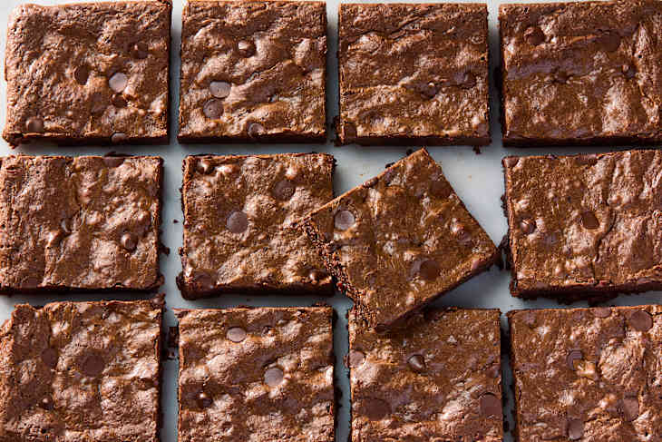 overhead shot of brownies cut into squares on a marble surface