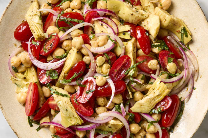 overhead shot of tuscan tomato artichoke salad in a large bowl