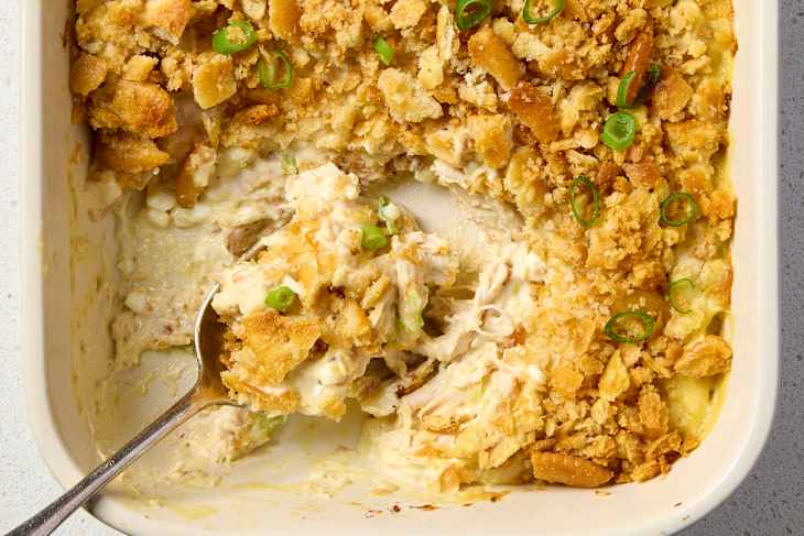 A spoonful of million dollar chicken casserole scooped out