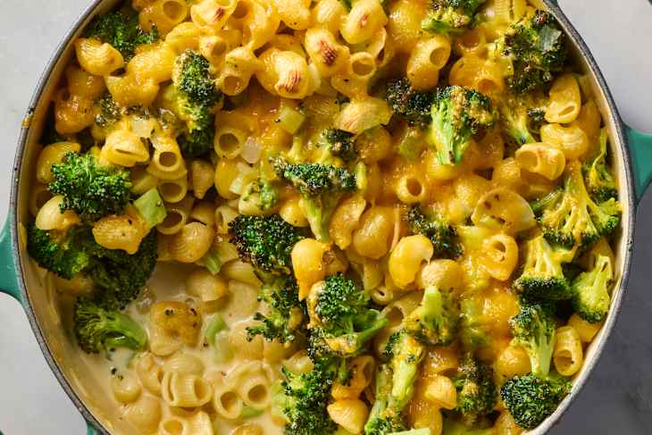 overhead shot of creamy broccoli pasta bake in a teal pot