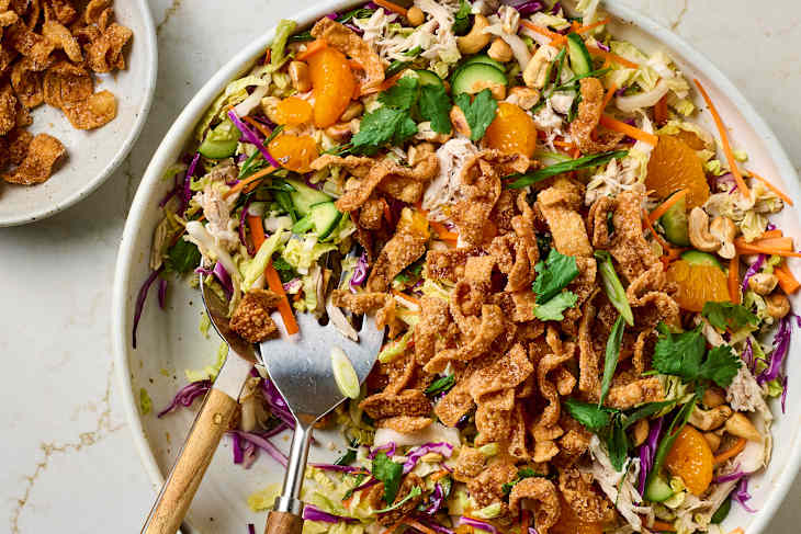 overhead shot of chopped chicken salad with sesame dressing in a large serving bowl