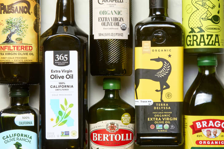 multiple different brands of olive oil on marble surface