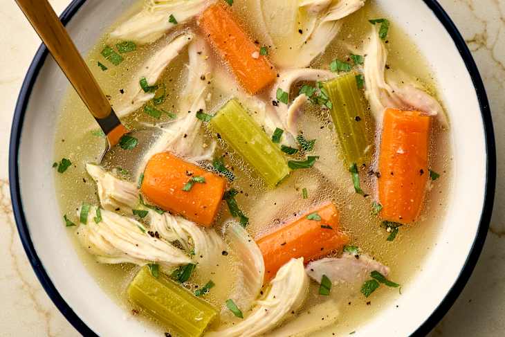 overhead shot of chicken soup in a bowl