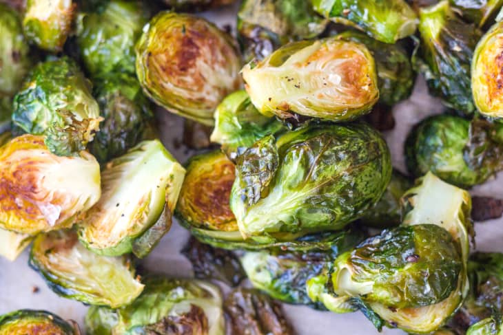 A close-up shot of oven-roasted Brussel sprouts, with a slightly charred exterior