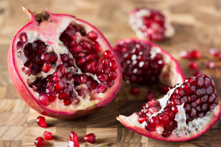 An open pomegranate on a wooden surface