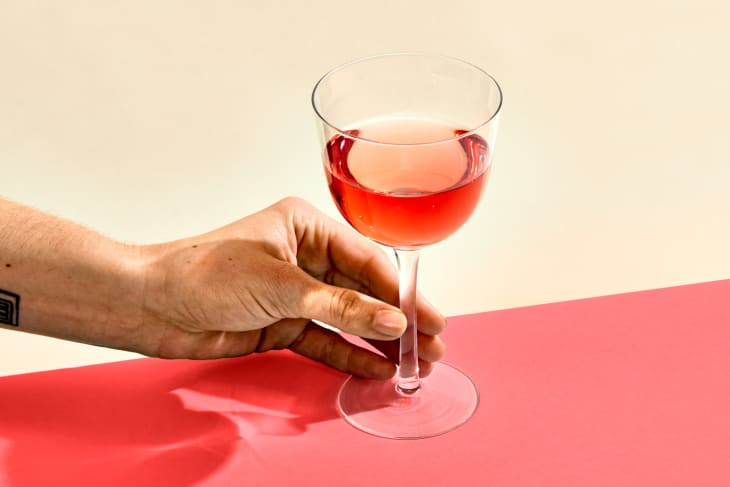 A glass of rose on a pink surface