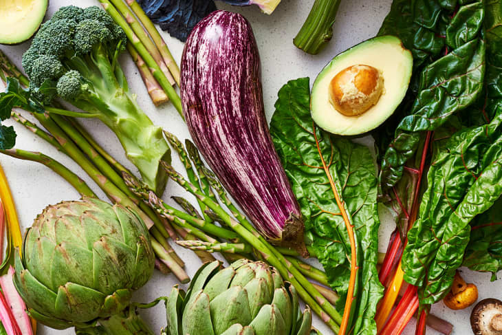 An abundance of vegetables including broccoli, avocado, eggplant, and asparagus