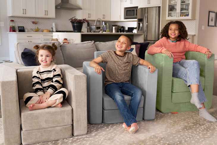 Children sitting on Nugget Smore's chair.