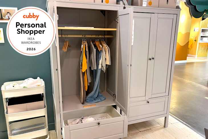 Wardrobe with hanging clothes, a drawer, and a storage cart with shoes, set in a bright, modern space.