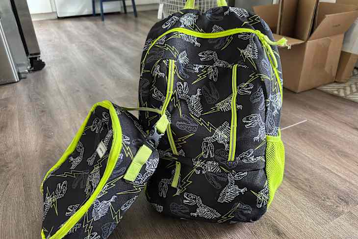 Backpack and lunch bag on kitchen floor.