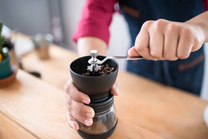 closeup of person using a coffee grinder