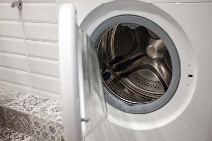 A mashing machine with an open door, no laundry inside