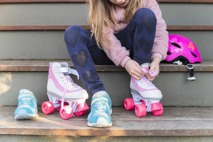 Girl tying the laces of her roller skates
