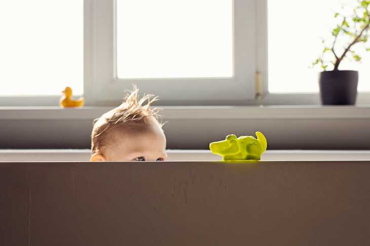 Little boy playing in the bathtub
