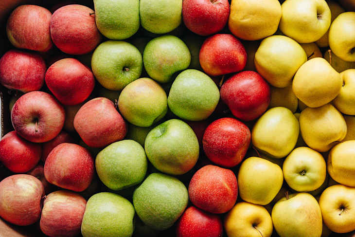 4 varieties of apples in a cardboard box