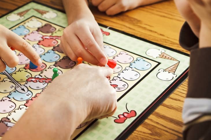 Closeup of Family Playing A Board Game Together