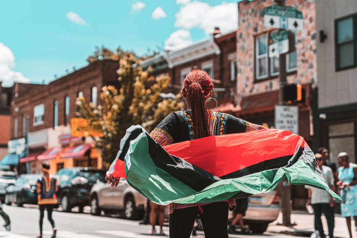 Woman holding flag in Juneteenth Parade