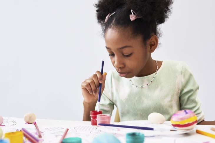 Minimal portrait of cute black girl enjoying art and craft class on Easter, copy space