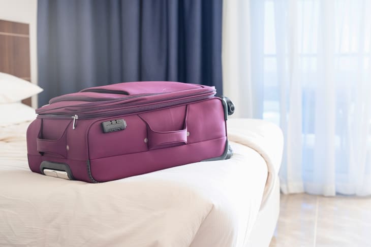 suitcase sitting on a bed