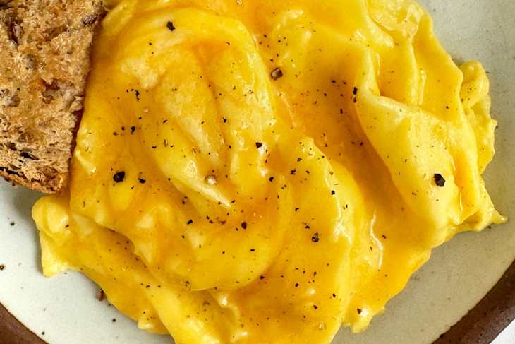 Spiral folded eggs on plate with toast