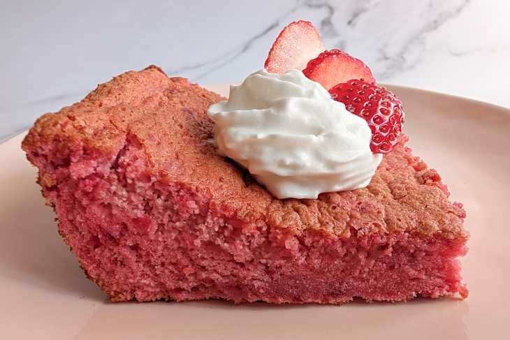 Whipped cream on top of strawberry cake.