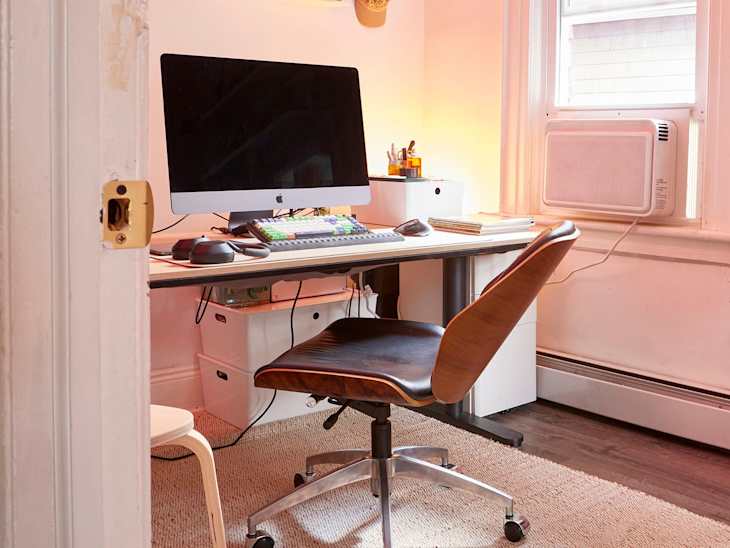 White workspace area with computer desk and pink light