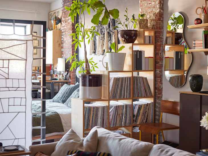 A fabric room divider flanked by stacks of record storage shelf.