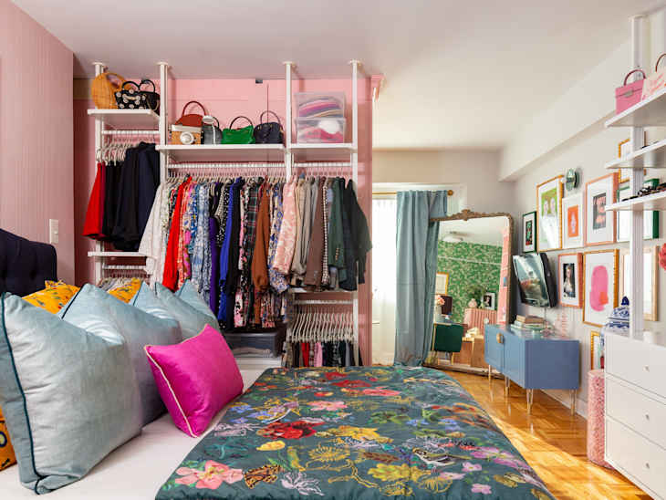 A bedroom with an open-face closet.