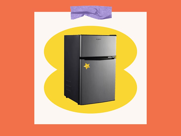 Stainless steel refrigerator with a yellow star sticker, set against a colorful background.