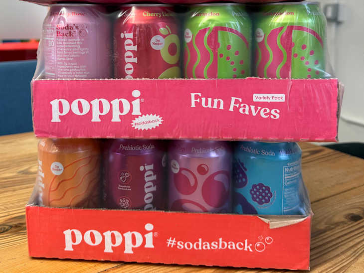 Variety pack of Poppi prebiotic sodas in colorful cans, featuring flavors like Cherry Limeade and Watermelon.