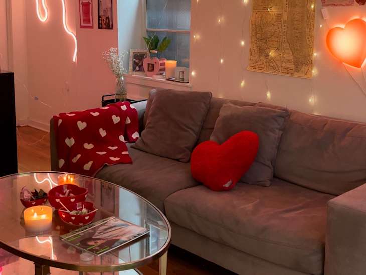 dorm room living area with lots of string lights, neon, and pink light