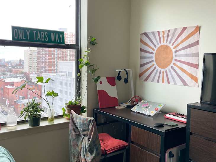 Art print above dorm room desk.