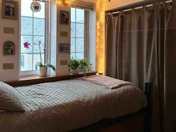 Lights strung across white wall in dorm