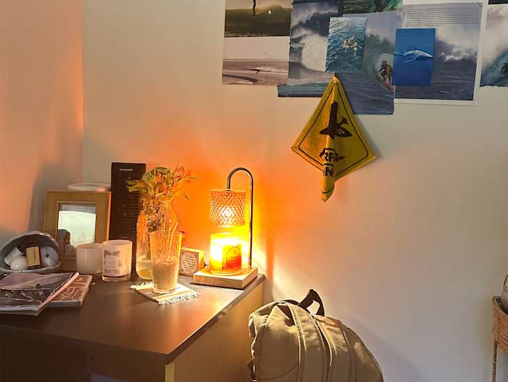 Candle warmer on dorm room desk.
