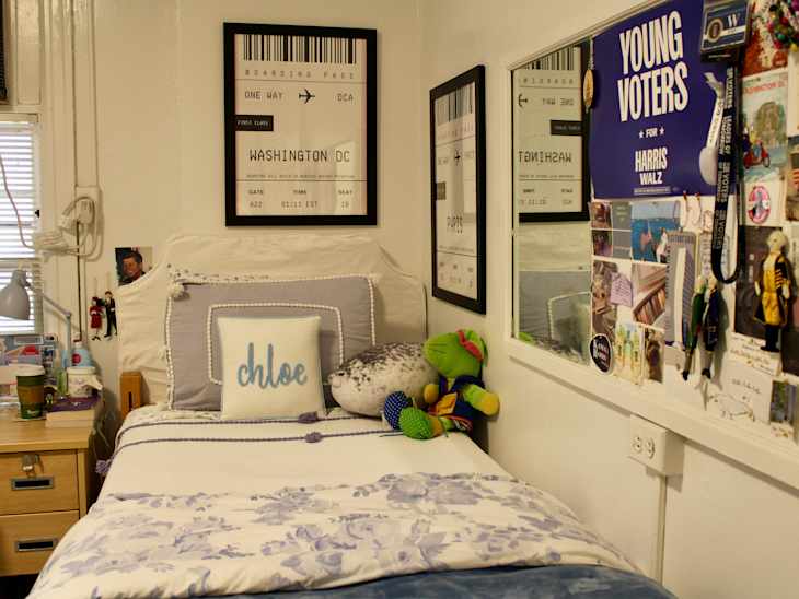 Neatly made bed in college dorm room.