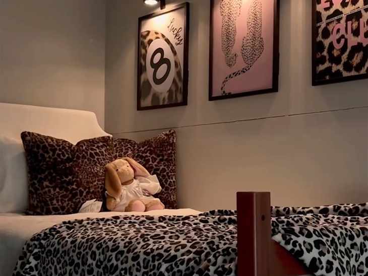 Animal print artwork on wall above bed in dorm room.