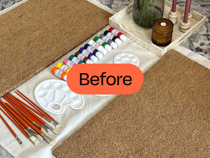 2 plain brown doormats with painting supplies in between them