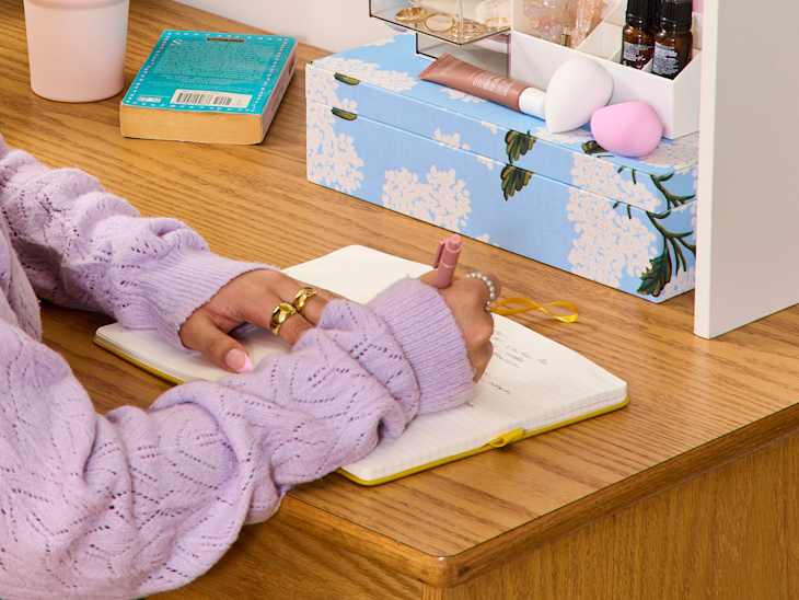 someone writing in a notebook