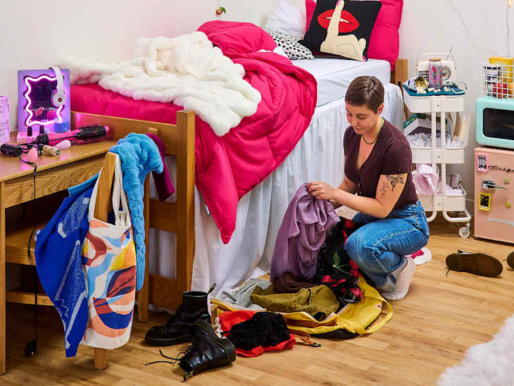 someone cleaning up clothes in a dorm