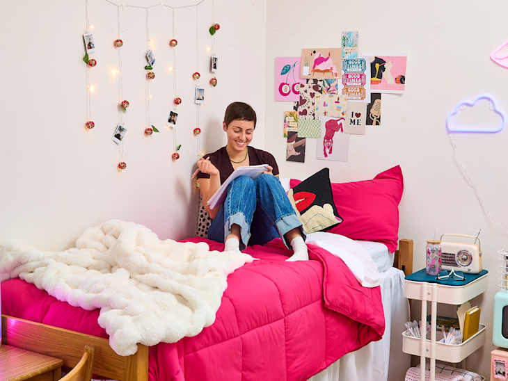 someone writing in an eclectic dorm setting