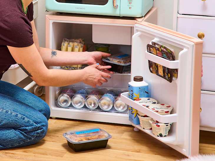 someone cleaning out a fridge